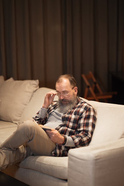 Man stretching gently on a yoga mat in his living room.
